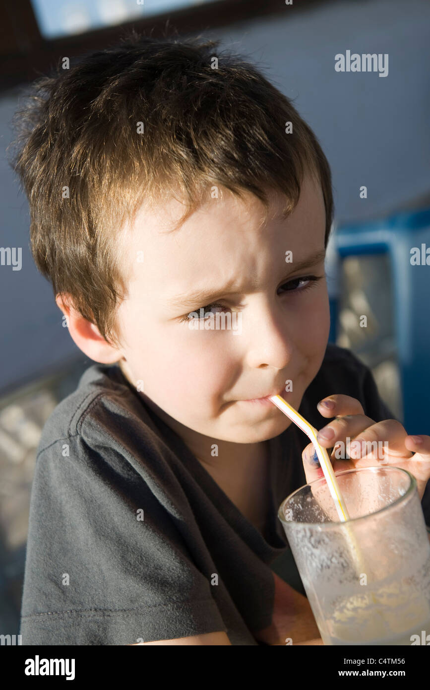 Boy drinking through straw, portrait Stock Photo Alamy