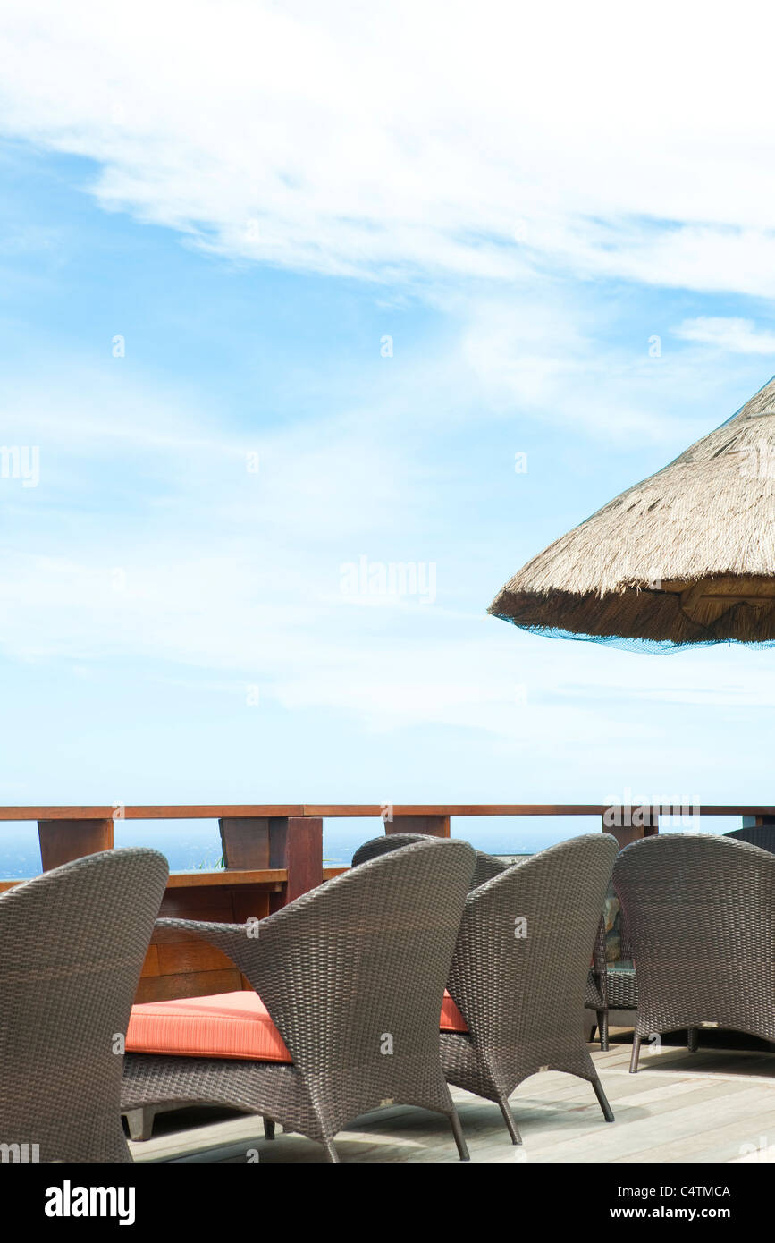 Wicker chairs lined up along deck Stock Photo - Alamy