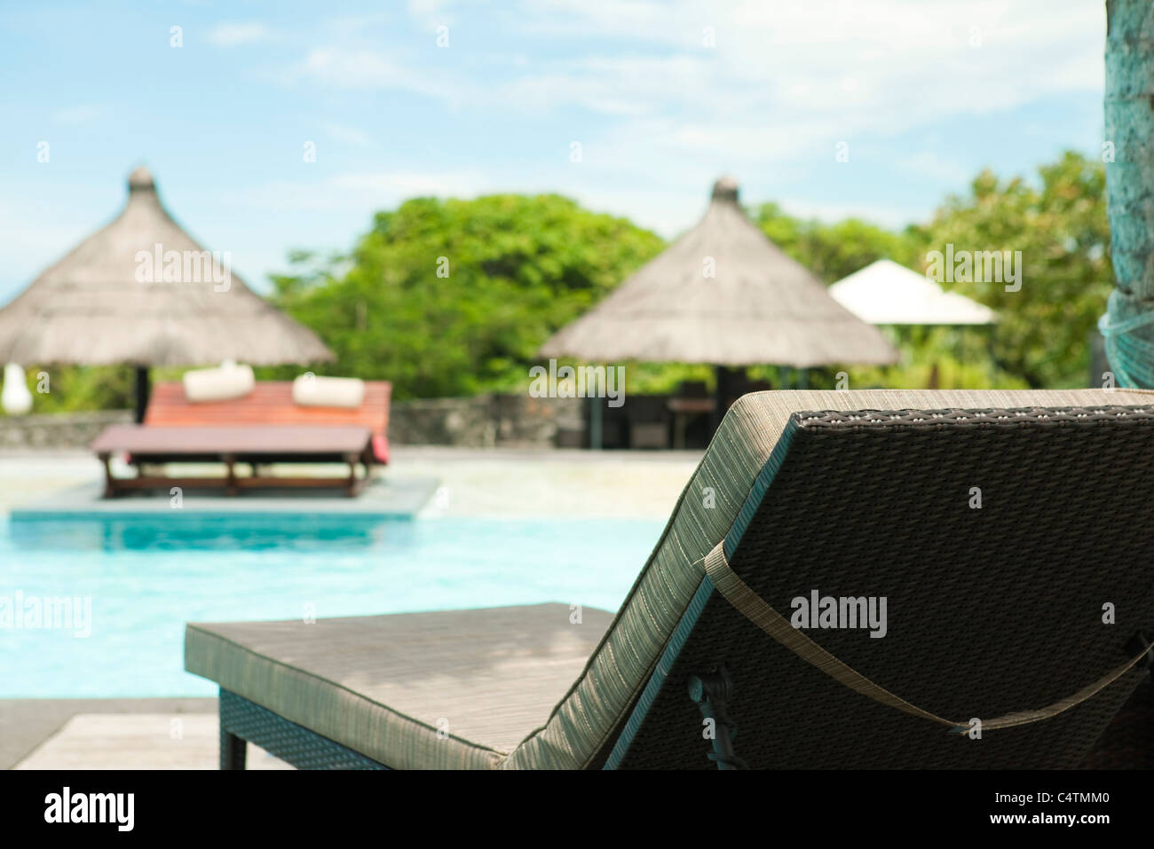 Lounge chair beside pool at resort Stock Photo Alamy