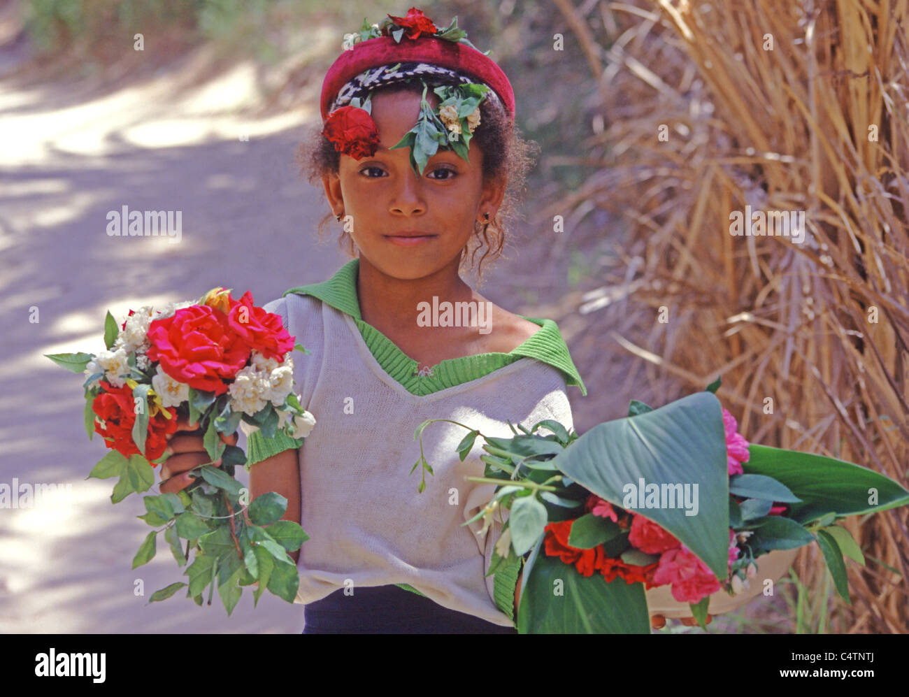 Tunisian Girl flower seller at Oasis in Southern Tunisia Stock Photo