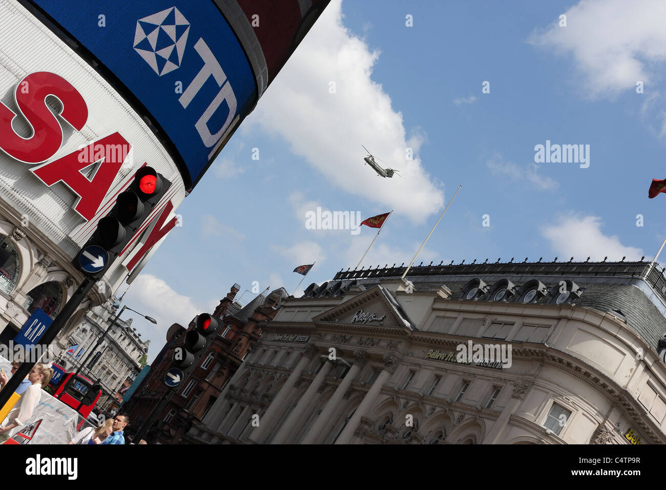 Chinook helicopter captured flying over Shaftesbury Avenue in the heart of London`s West End, viewed at an extreme angled aspect. Stock Photo