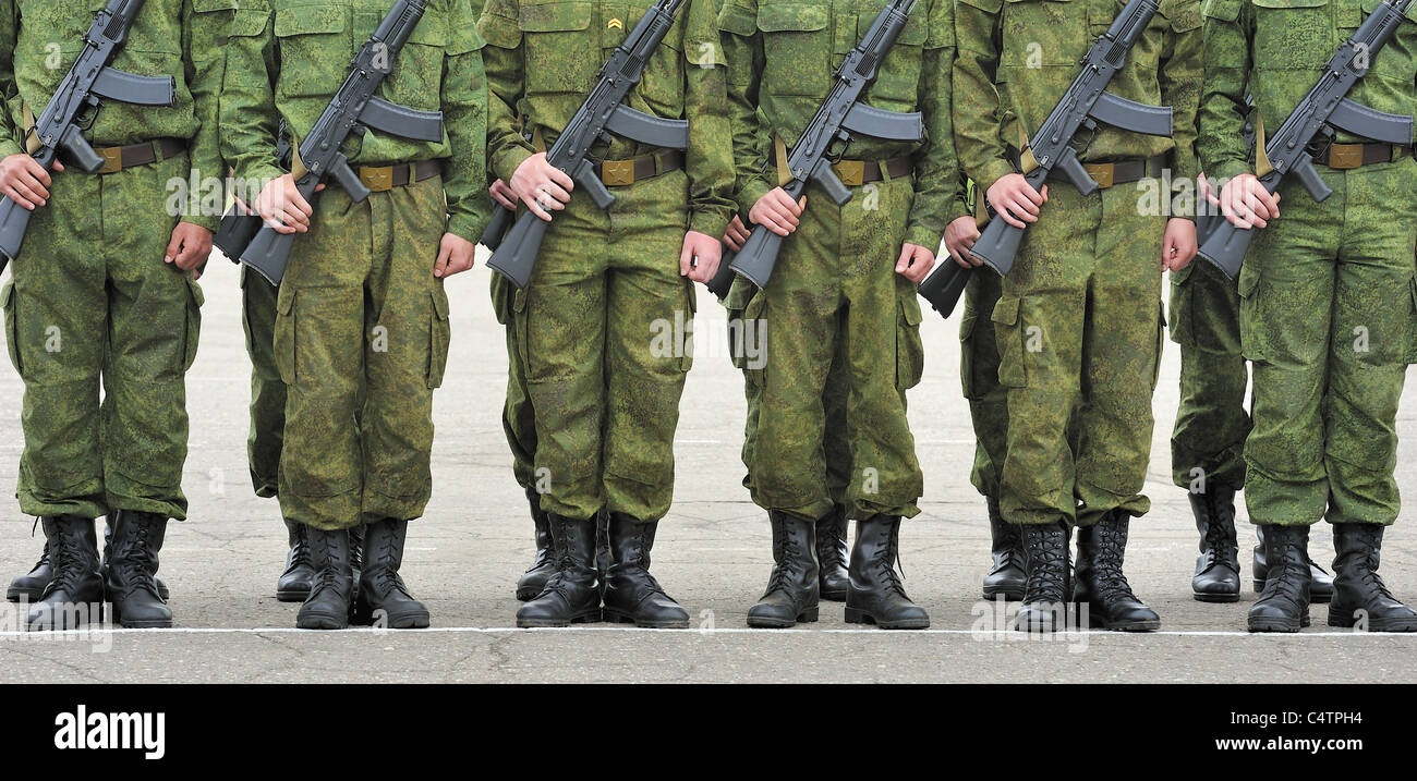 russian soldiers in camouflage suit with machine guns Kalashnikov Stock Photo