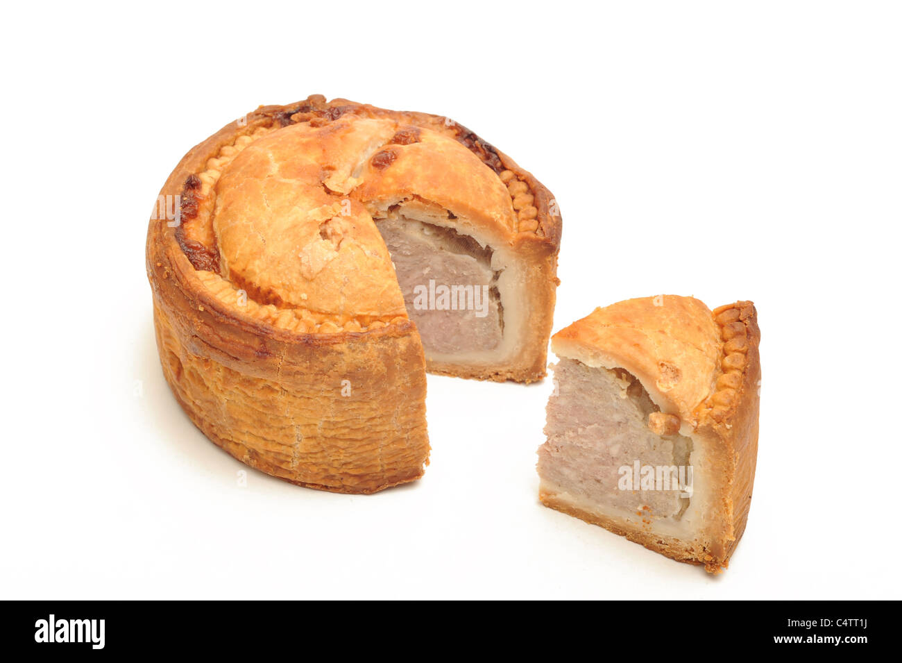 Photograph of pork pie and a slice taken out Stock Photo