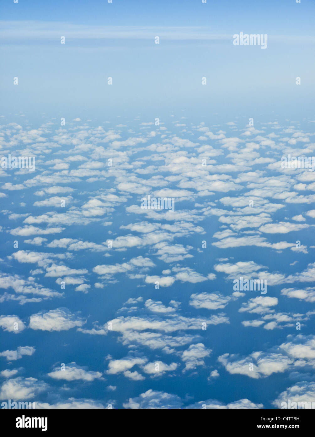 PUFFY SMALL CLOUDS AND BLUE SKY SHOT FROM PLANE Stock Photo