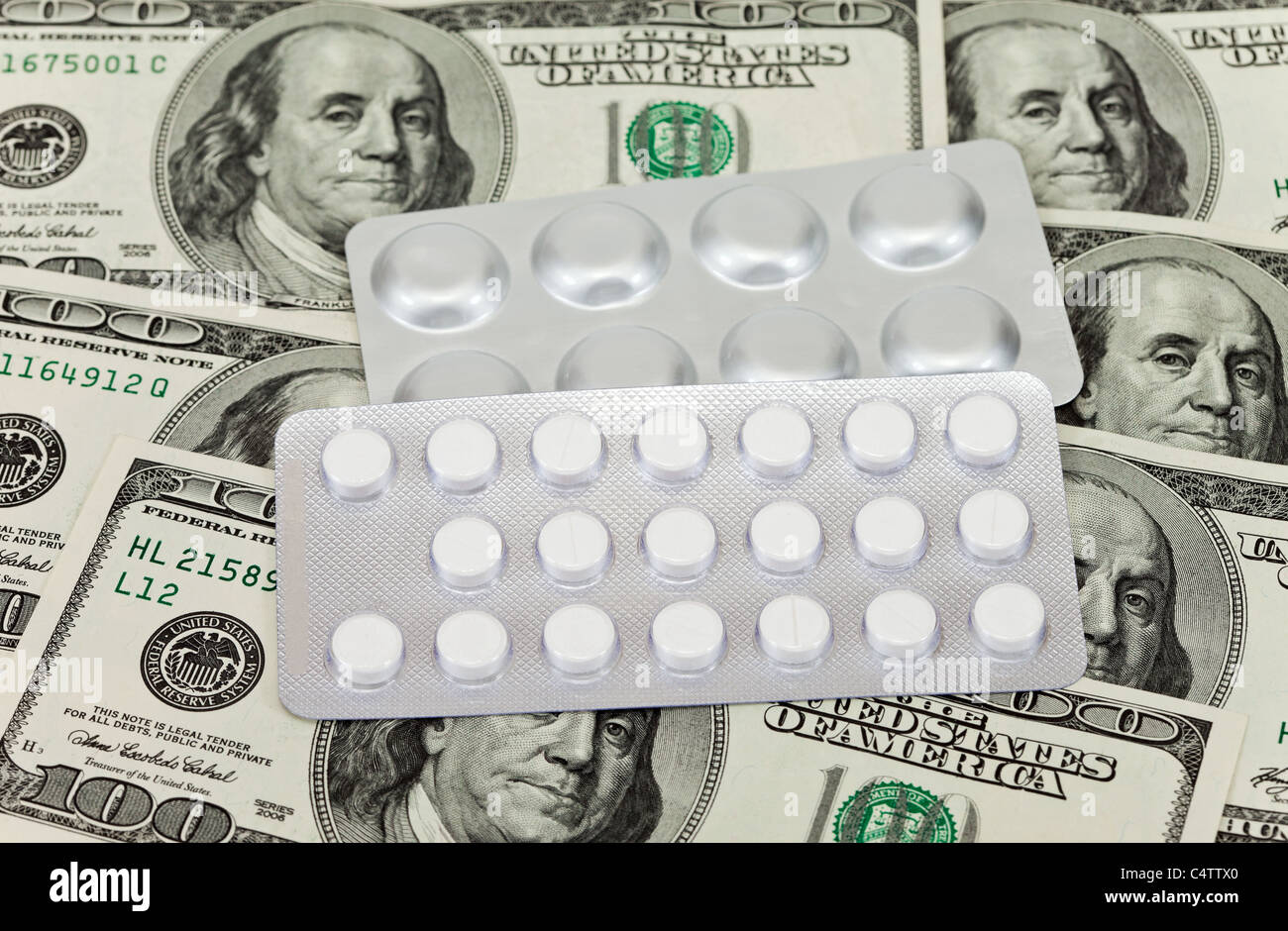 Costly Daily Medication on a money background Stock Photo