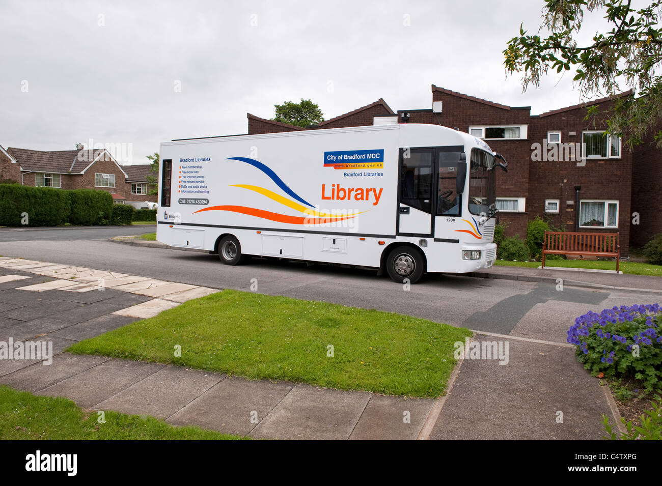 Mobile library van lorry parked by residential retirement houses (serving community with outreach resource & facility) - West Yorkshire, England, UK. Stock Photo