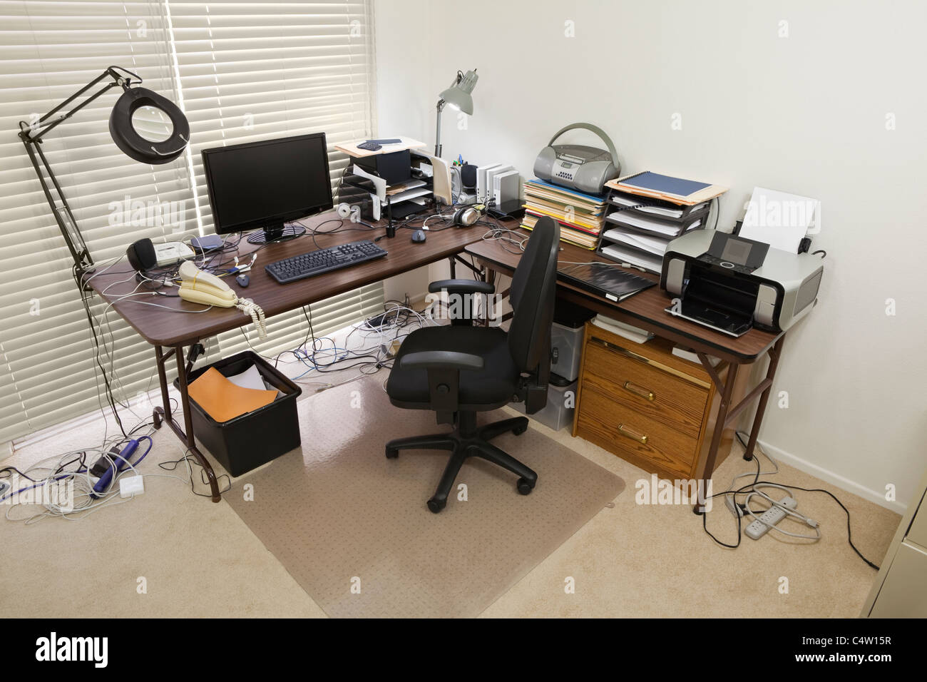 Upstairs home office with chaos of cords. Stock Photo
