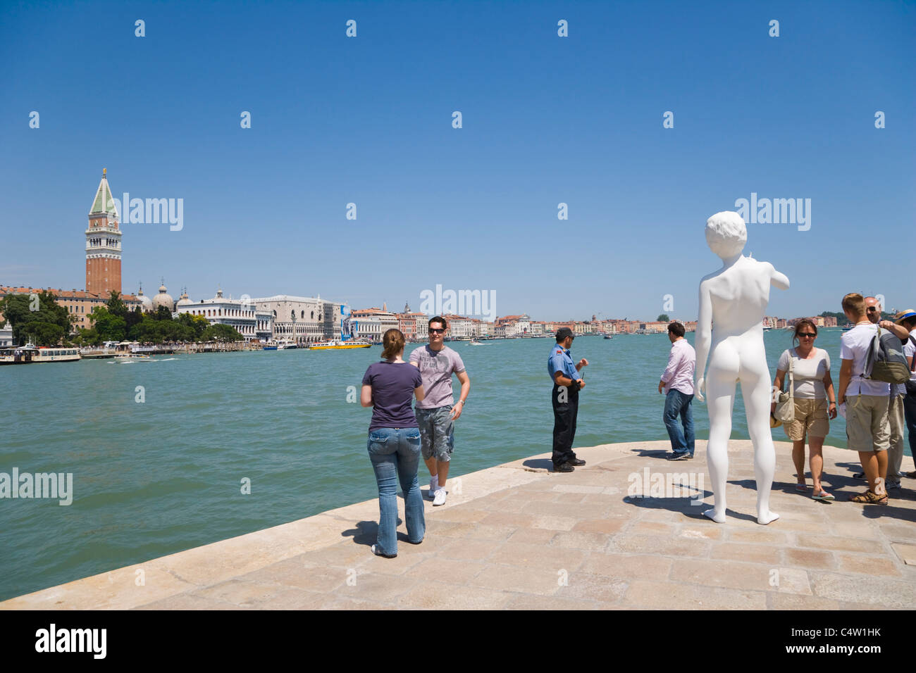 Punta della Dogana with Charles Ray's sculpture Boy with Frog against view of Venice with Giardini ex Reali, Venice, Italy Stock Photo