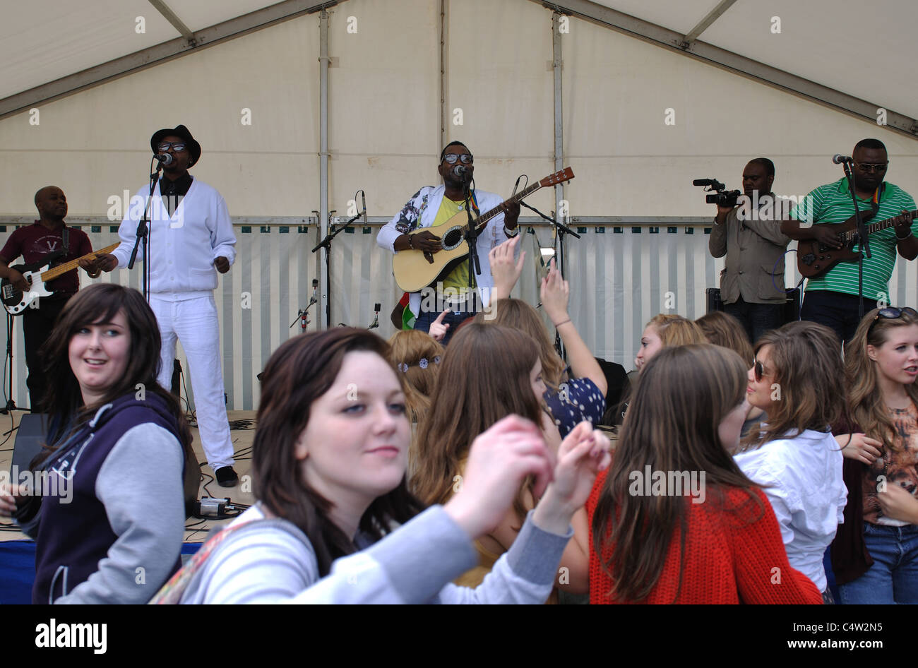 Teenage girls dancing to live band at Leamington Peace Festival Stock Photo