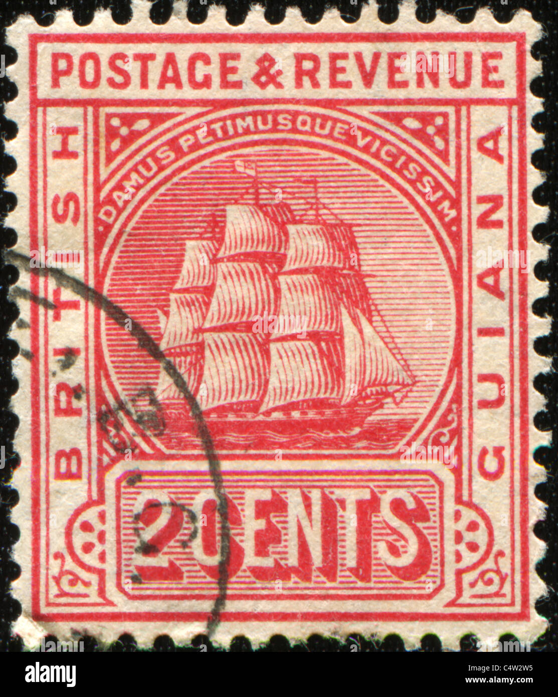 BRITISH GUAINA - CIRCA 1876: A stamp printed in British Guiana shows frigate and Latin phrase Damus petimusue vicissim Stock Photo