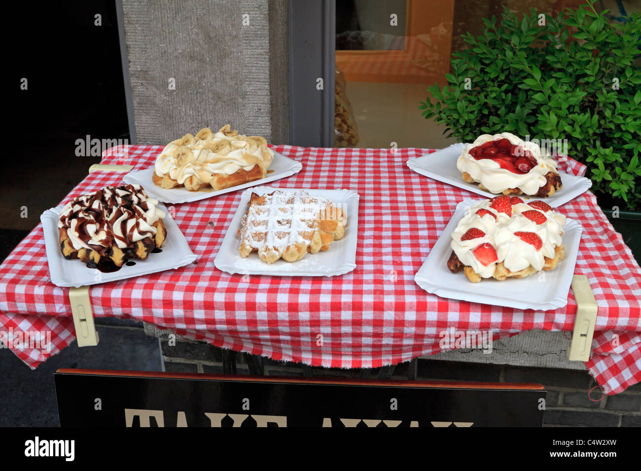 Assortment of Belgian waffles on display outside a restaurant in Bruges