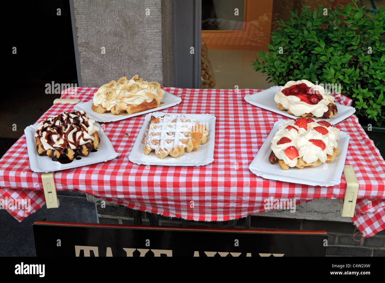 Assortment of Belgian waffles on display outside a restaurant in Bruges, Belgium Stock Photo