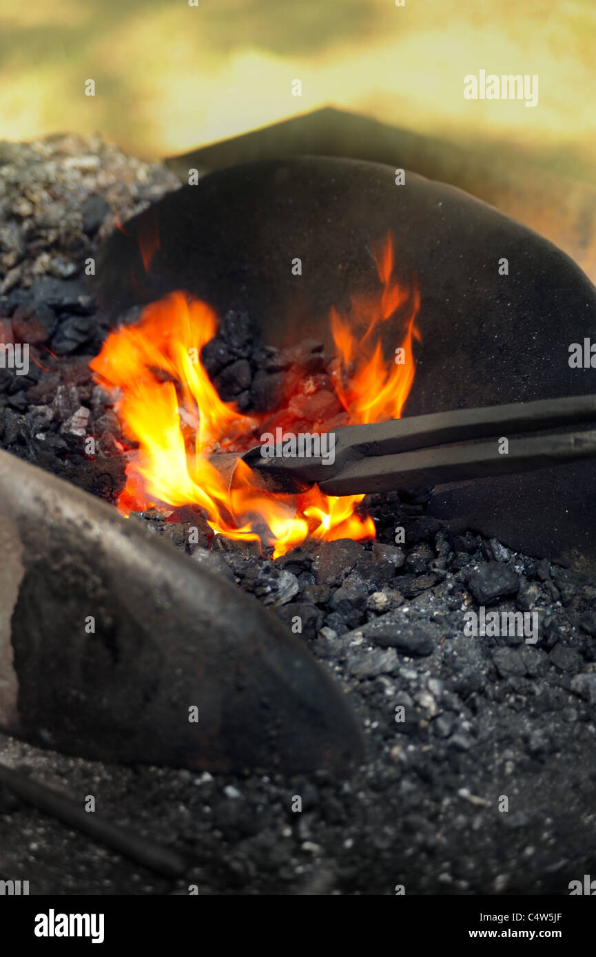 Blacksmith heating up iron in furnace detail Stock Photo Alamy
