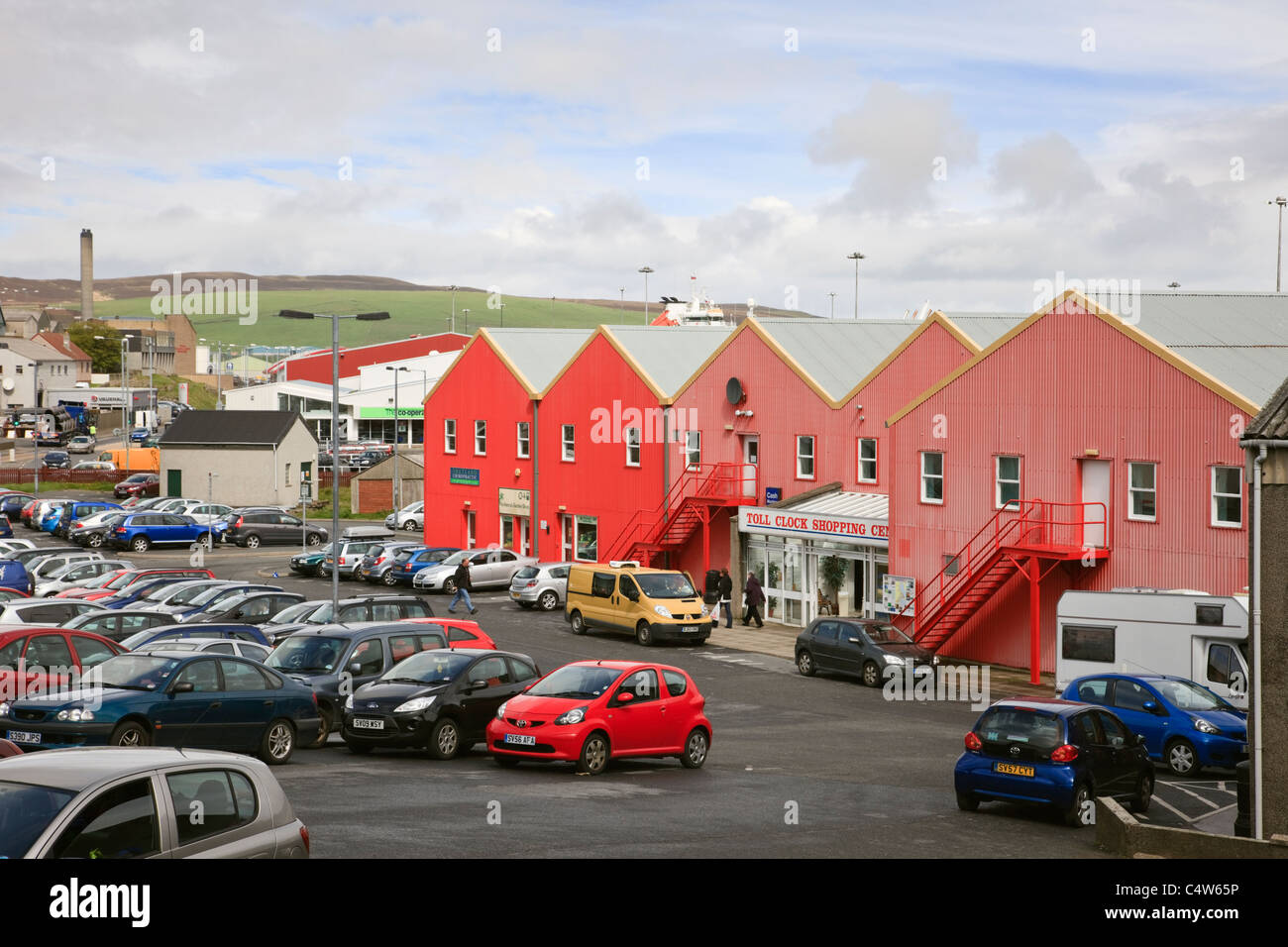 Toll Clock shopping centre in red building and car park. Lerwick