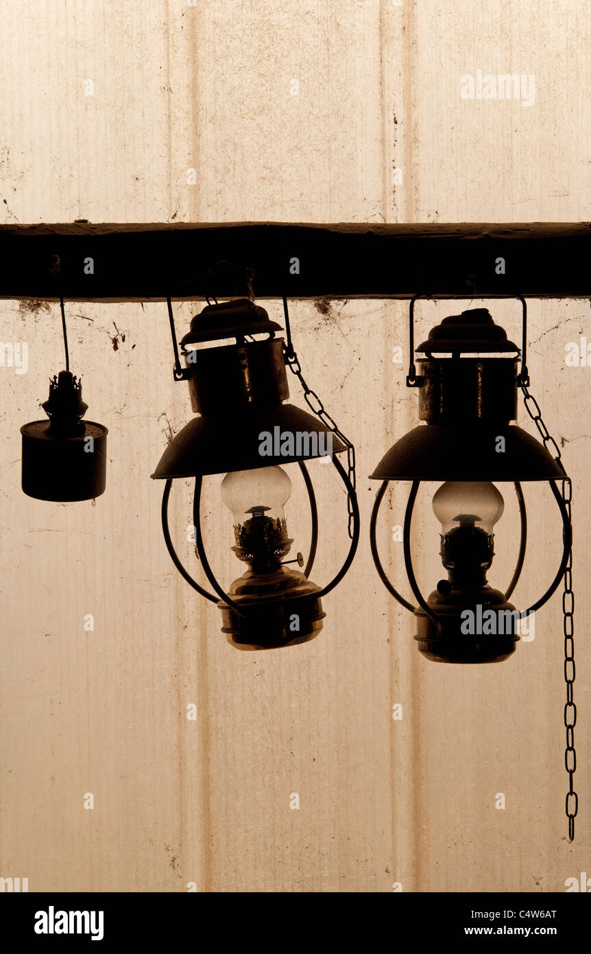 old paraffin lamps hanging in a barn Stock Photo