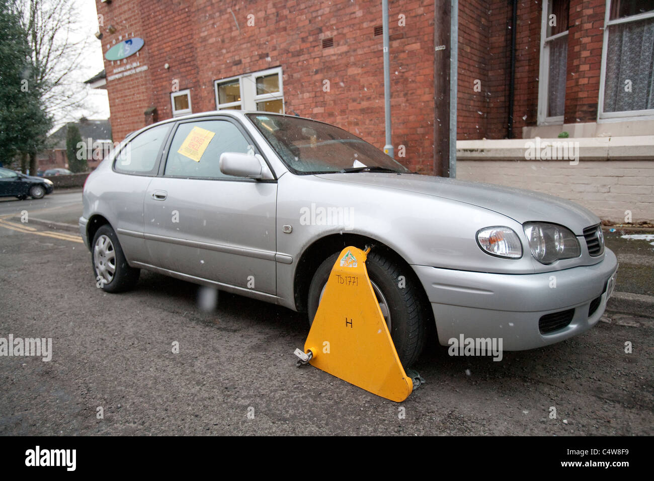 Untaxed Car clamped by the DVLA, Untaxed vehicle wheel clamped Stock