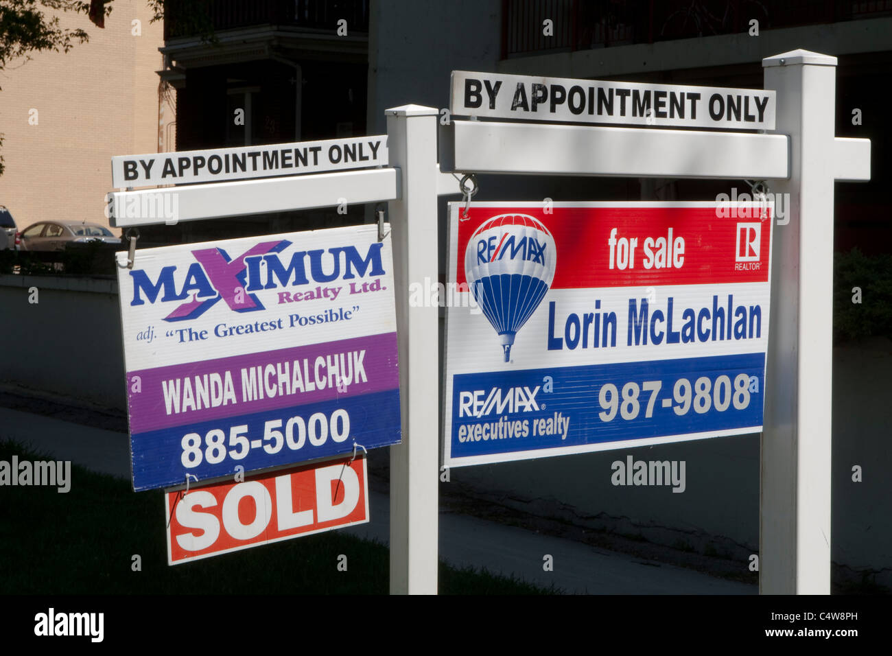 'For sale' signs for Maximum realty and Re/Max are seen next to each other in Winnipeg Thursday May 26, 2011. Stock Photo