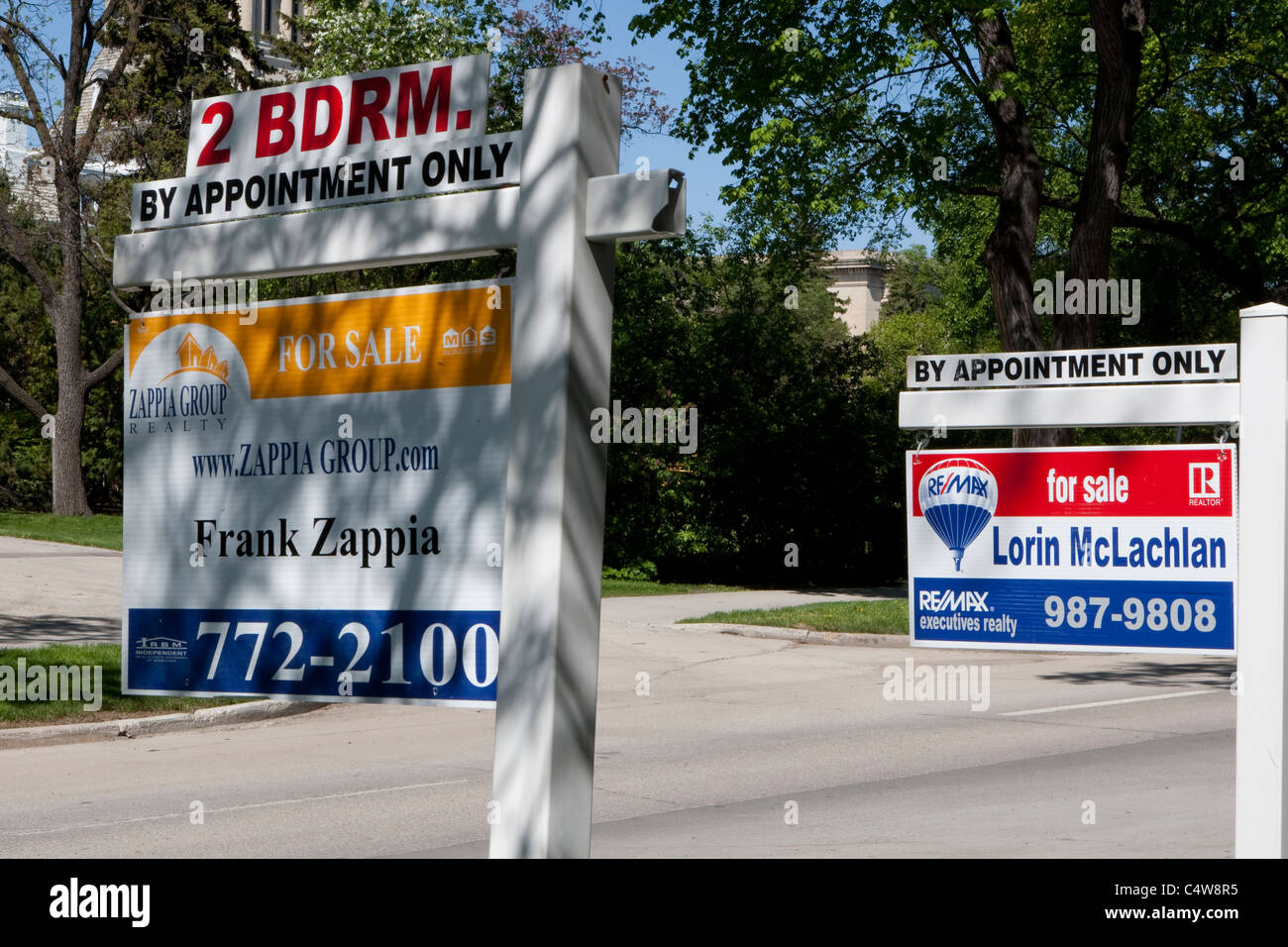 'For sale' signs for Re/Max and Zappia Group realty are seen next to each other in Winnipeg Thursday May 26, 2011. Stock Photo