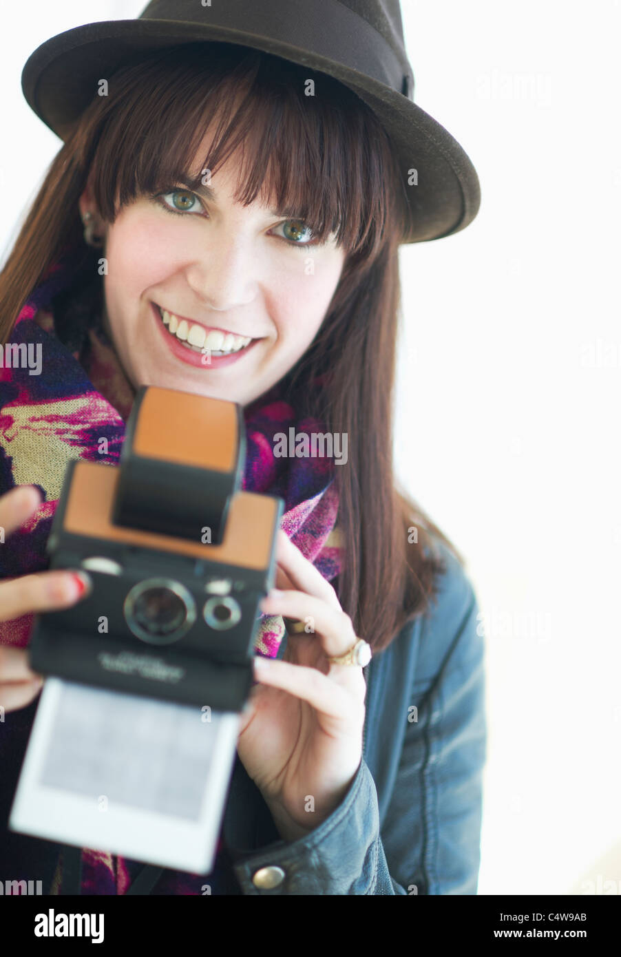 Portrait of young woman with instant camera Stock Photo