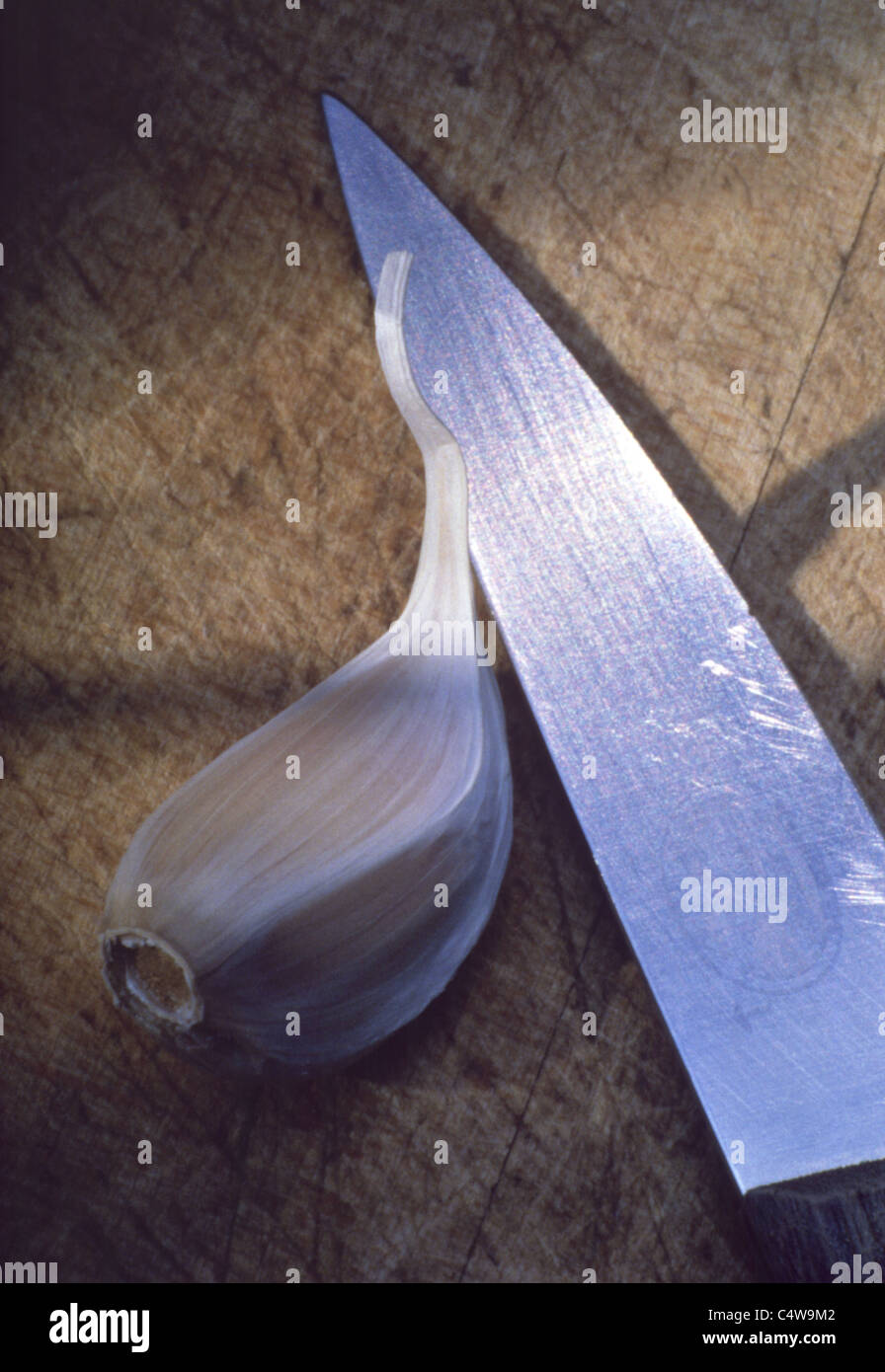 Still Kitchen knife with clove of garlic Stock Photo Alamy