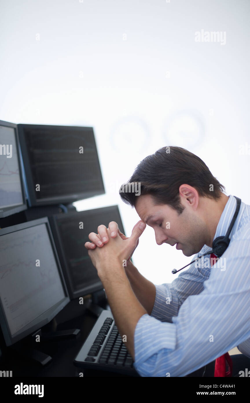 USA,New Jersey,Jersey City,upset financial worker analyzing data displayed on computer screen Stock Photo