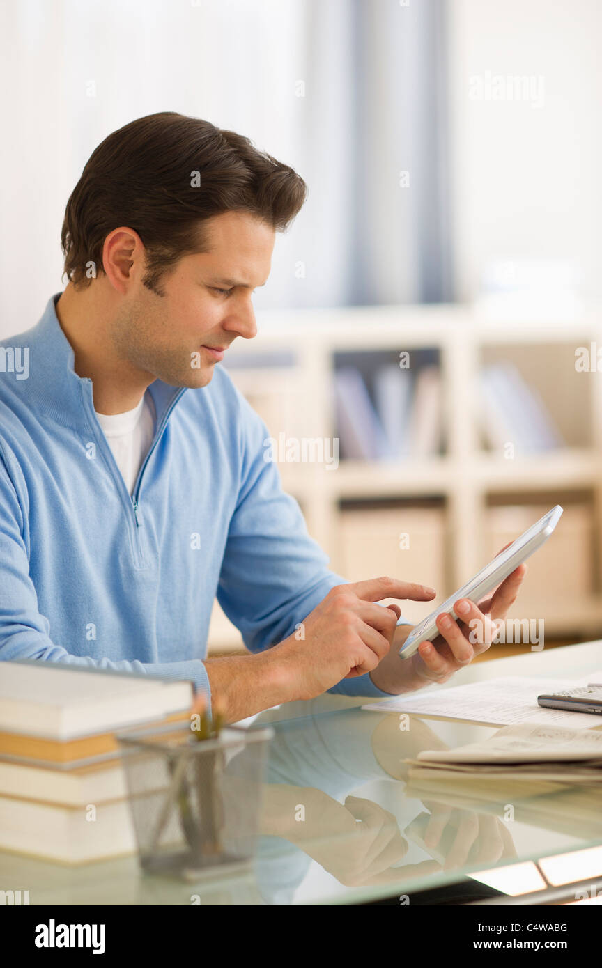 USA,New Jersey,Jersey City,man using digital tablet at home office Stock Photo