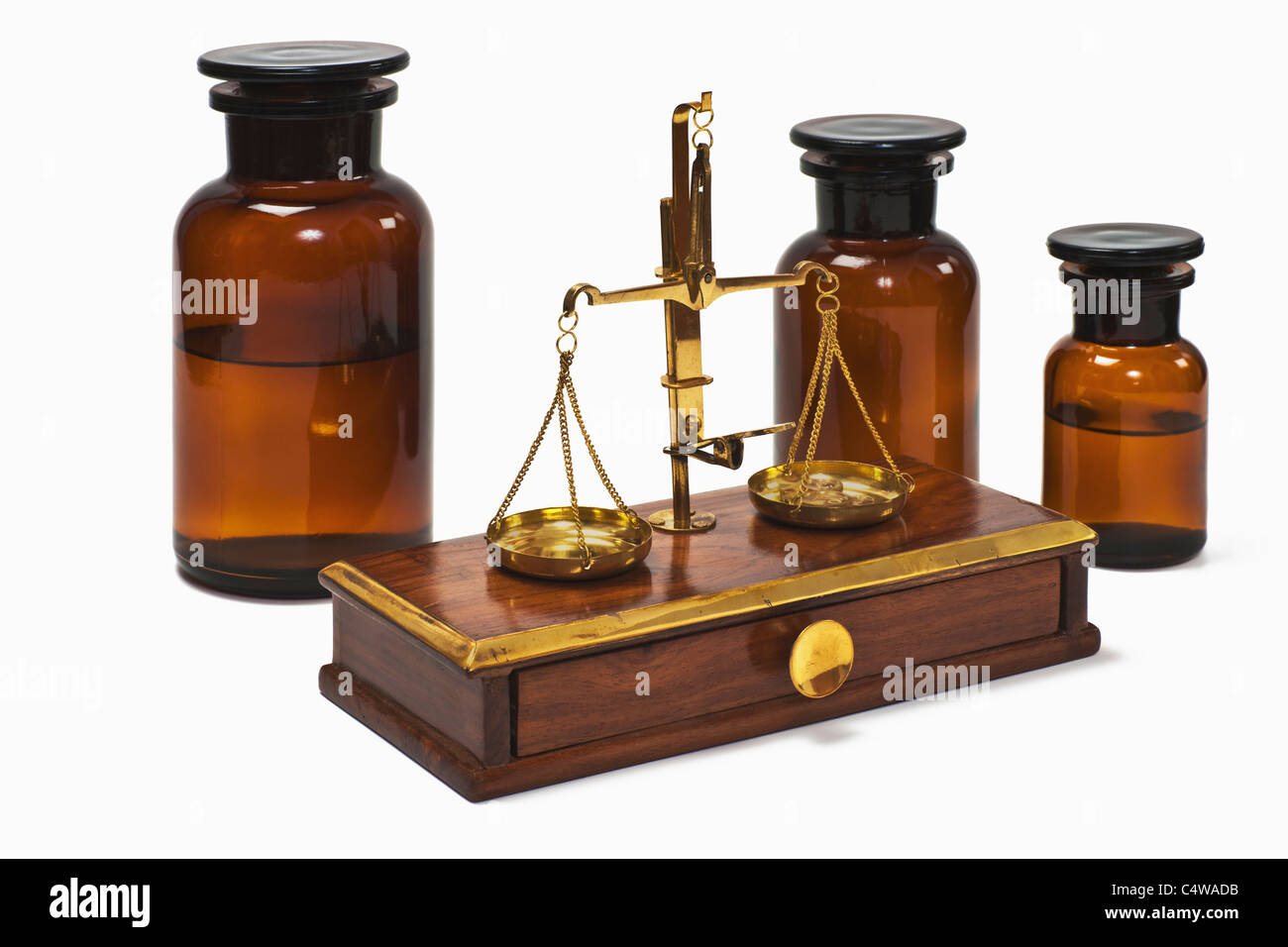 Detail photo of a old druggist balance alongside are three pharmacists bottles Stock Photo
