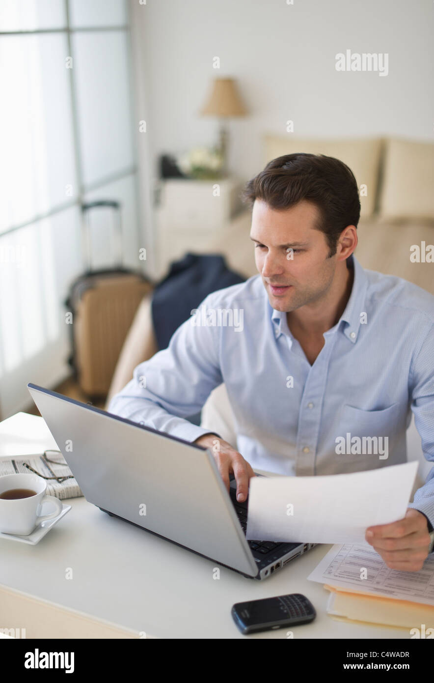 USA,New Jersey,Jersey City,man using laptop at home office Stock Photo