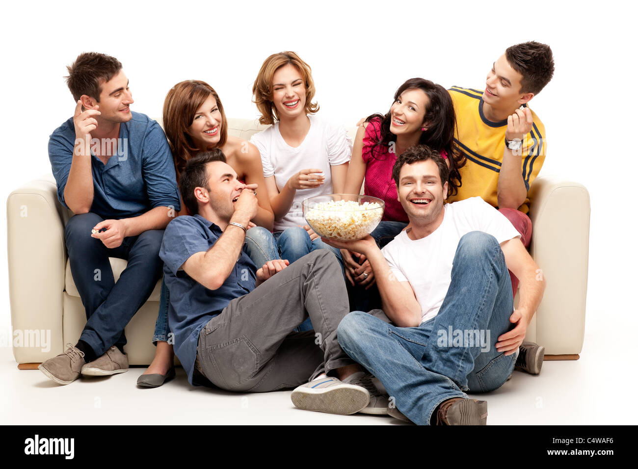 friends sitting on couch laughing at comedy movie Stock Photo Alamy