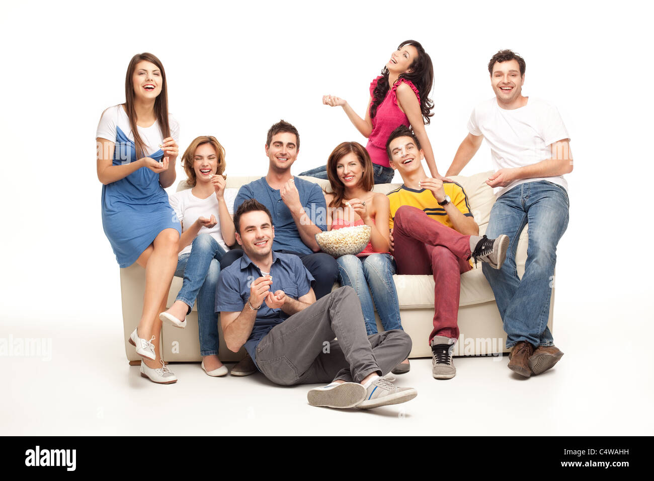 friends sitting on couch laughing at comedy movie Stock Photo Alamy