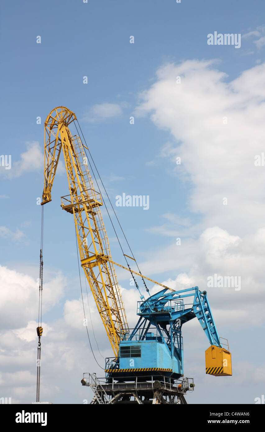 The elevating crane in river port against the sky Stock Photo