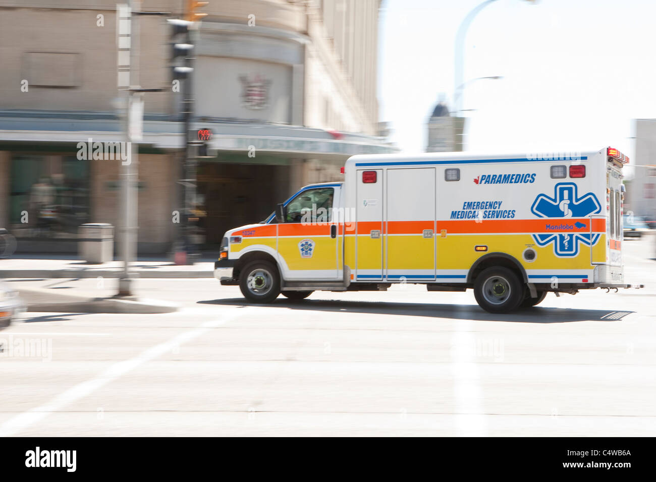 A Manitoba Paramedics ambulance runs into Winnipeg streets Wednesday May 25, 2011 Stock Photo