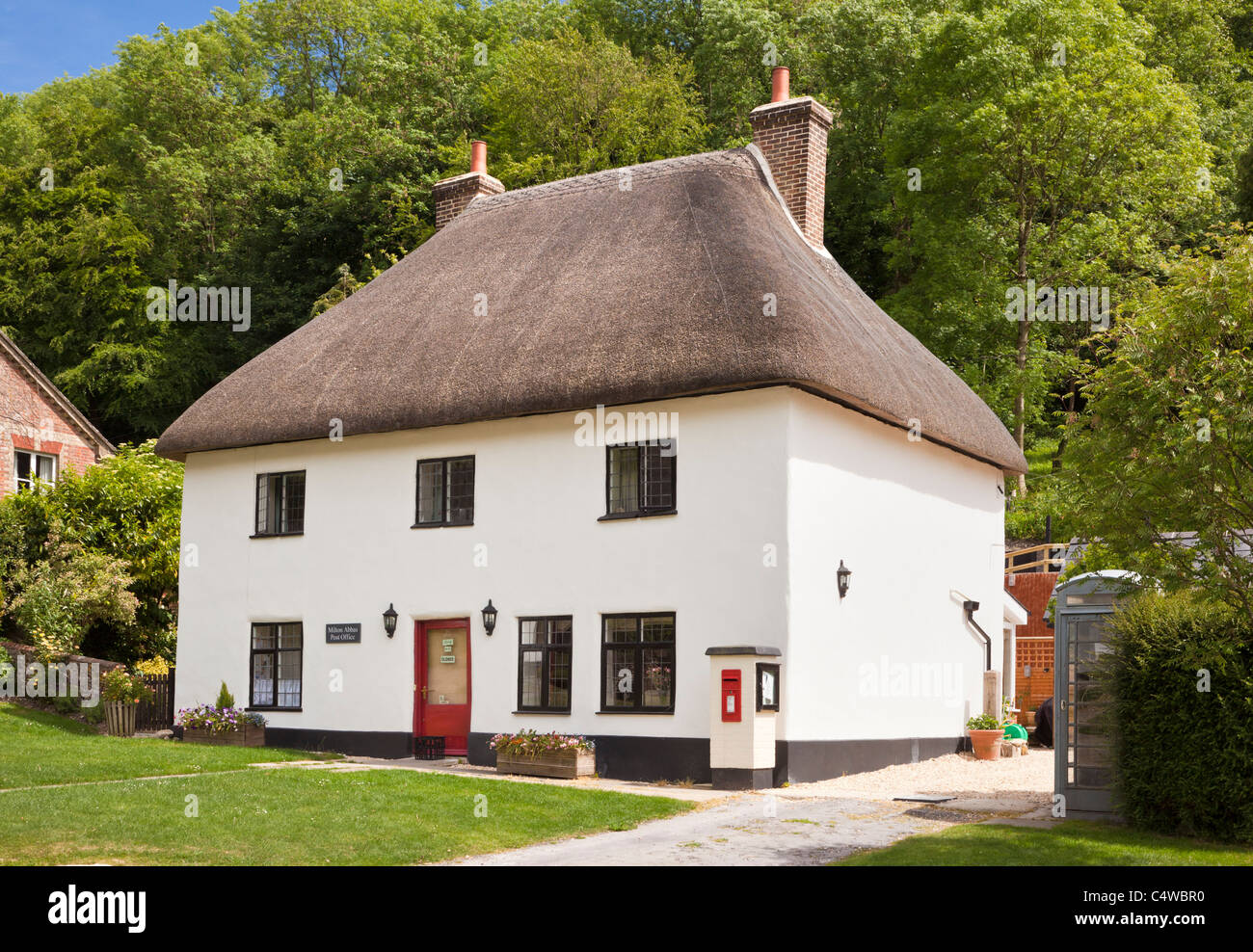 Pretty thatched British village post office and store, Milton Abbas, Dorset, England, UK Stock Photo
