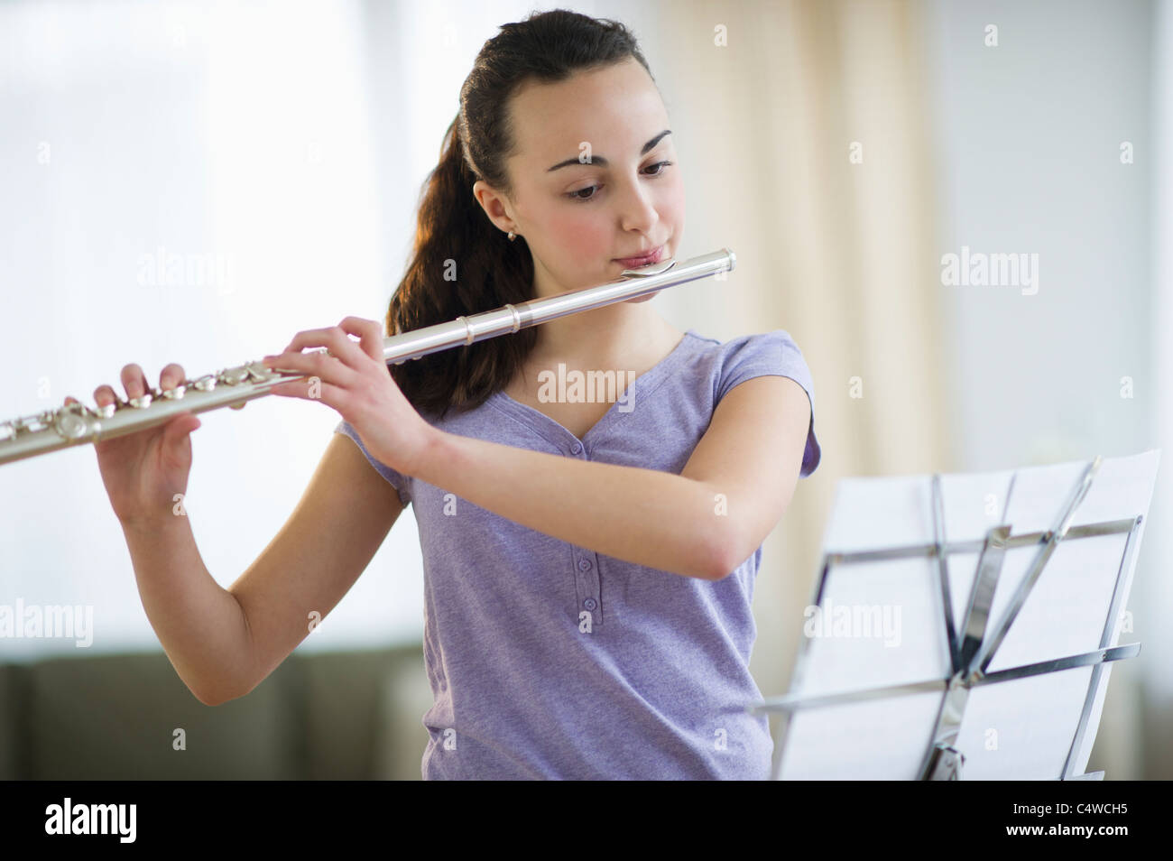 USA, New Jersey, Jersey City, Teenage girl (14-15) playing flute Stock Photo