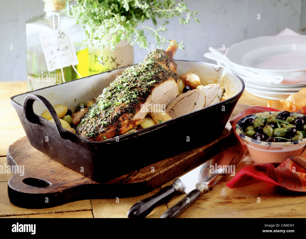 Herb haunch of lamb with olive potatoes Stock Photo Alamy