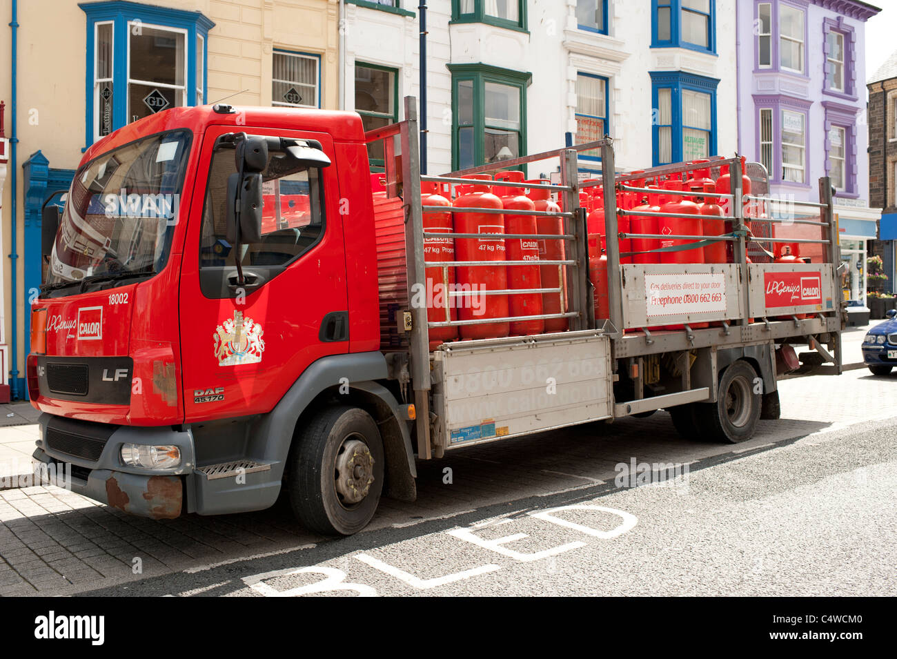 A delivery of orange coloured Calor propane gas bottles cylinders, UK