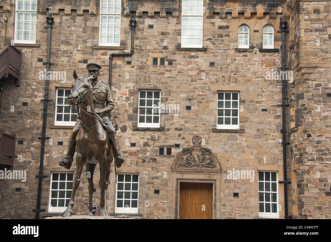 Scotland, Edinburgh. Historic Edinburgh Castle. Statue of Earl Haig in front of hospital building. Stock Photo
