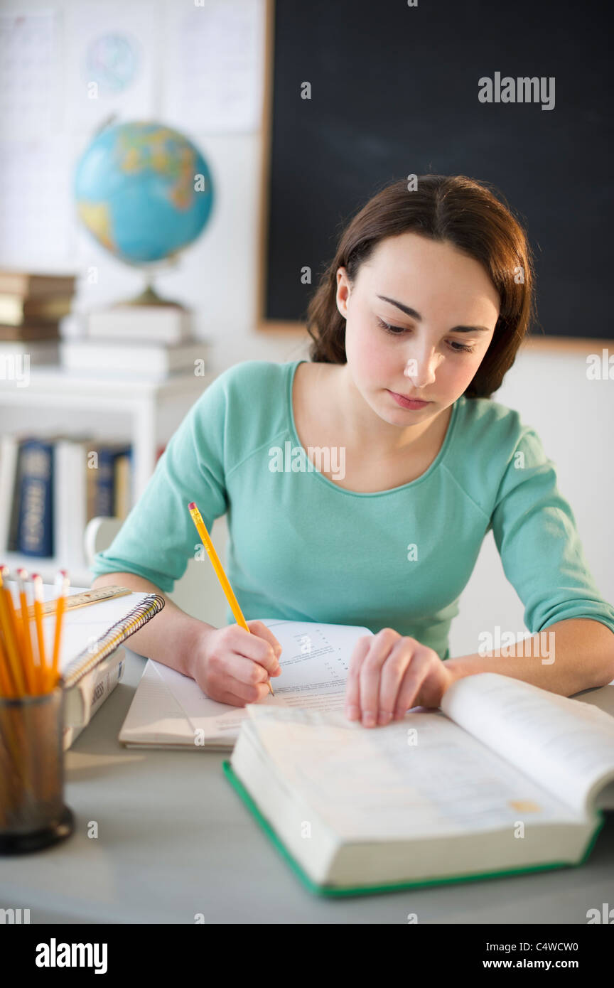 USA,New Jersey,Jersey City,Teenage girl (14-15) doing homework Stock Photo