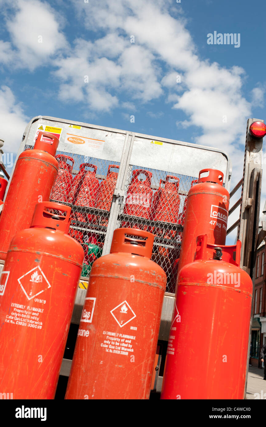 A delivery of orange coloured Calor propane gas bottles cylinders, UK Stock Photo