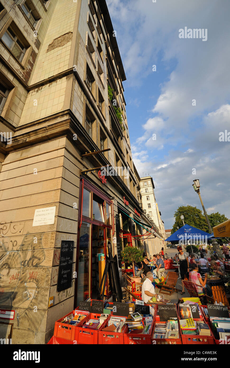 Book shop and street café, Karl-Marx-Allee, Frankfurter Allee, former Stalinallee, Friedrichshain, Berlin, Germany. Stock Photo
