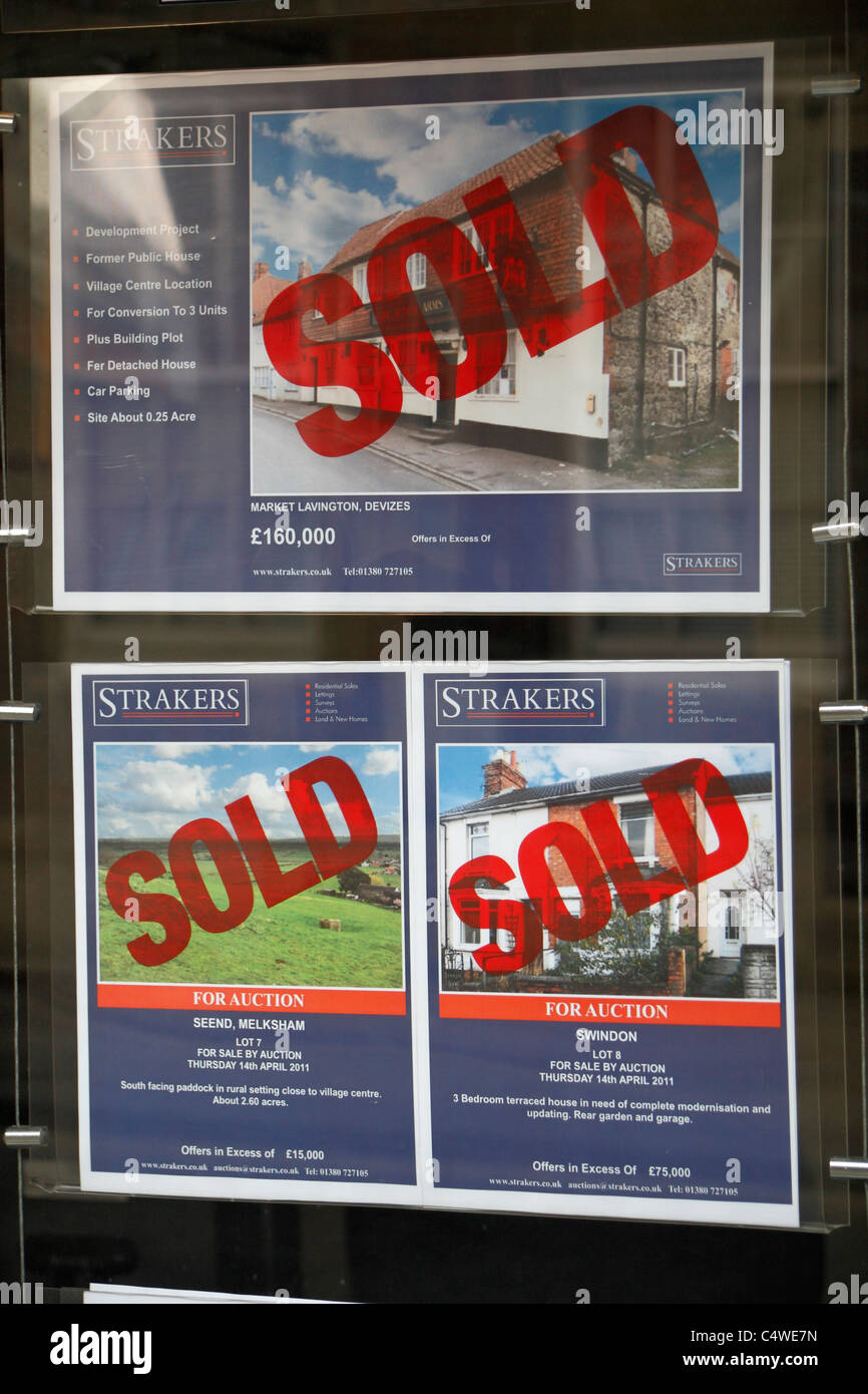 An estate agents window shopping three for sale properties as 'Sold' in Devizes, Wiltshire, England. Stock Photo