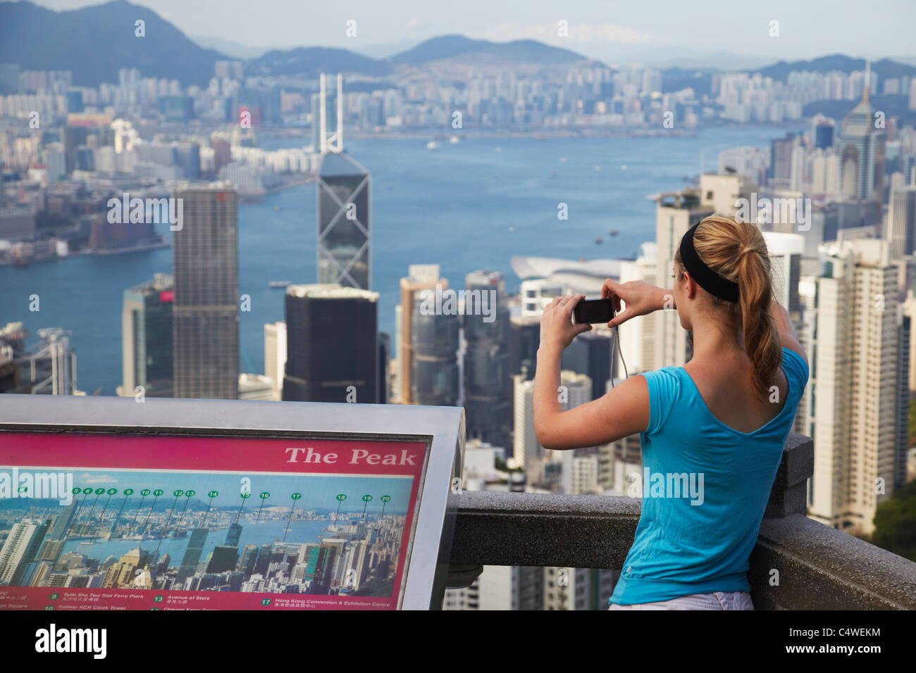 Woman taking photo of Hong Kong Island skyline from Victoria Peak, Hong ...