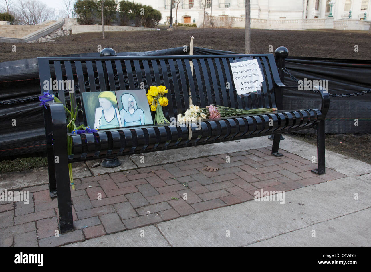 Bench at Wisconsin capitol sign reads, 'The work goes on, the cause endures, the hope still lives and the dream shall never die' Stock Photo