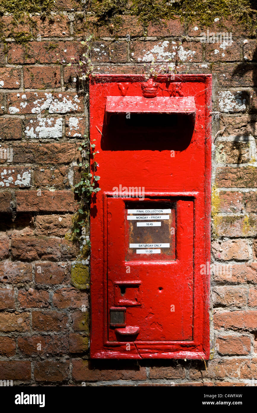 A Victoria Regina postbox in a brick wall. Bury St Edmunds, Suffolk, UK Stock Photo