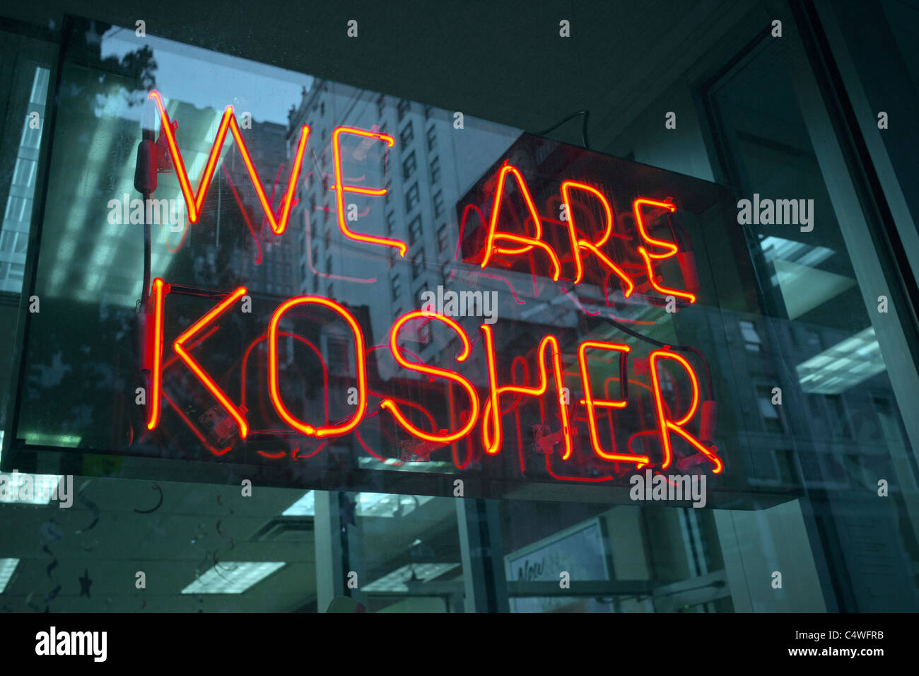 A sign in the window of a Dunkin Donuts in New York advertises that they are kosher and observe Jewish dietary laws Stock Photo