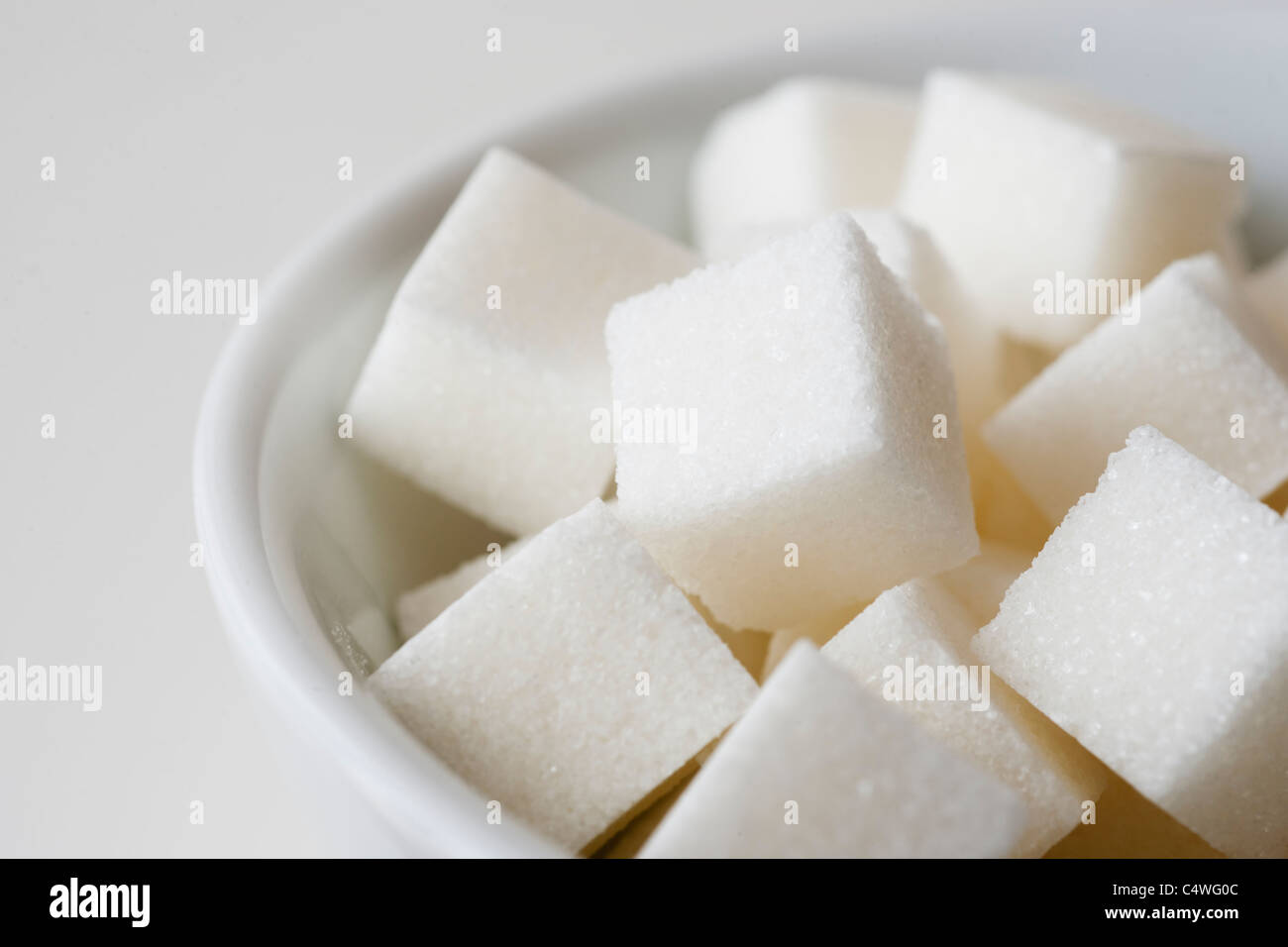 Studio shot of sugar cubes in bowl Stock Photo