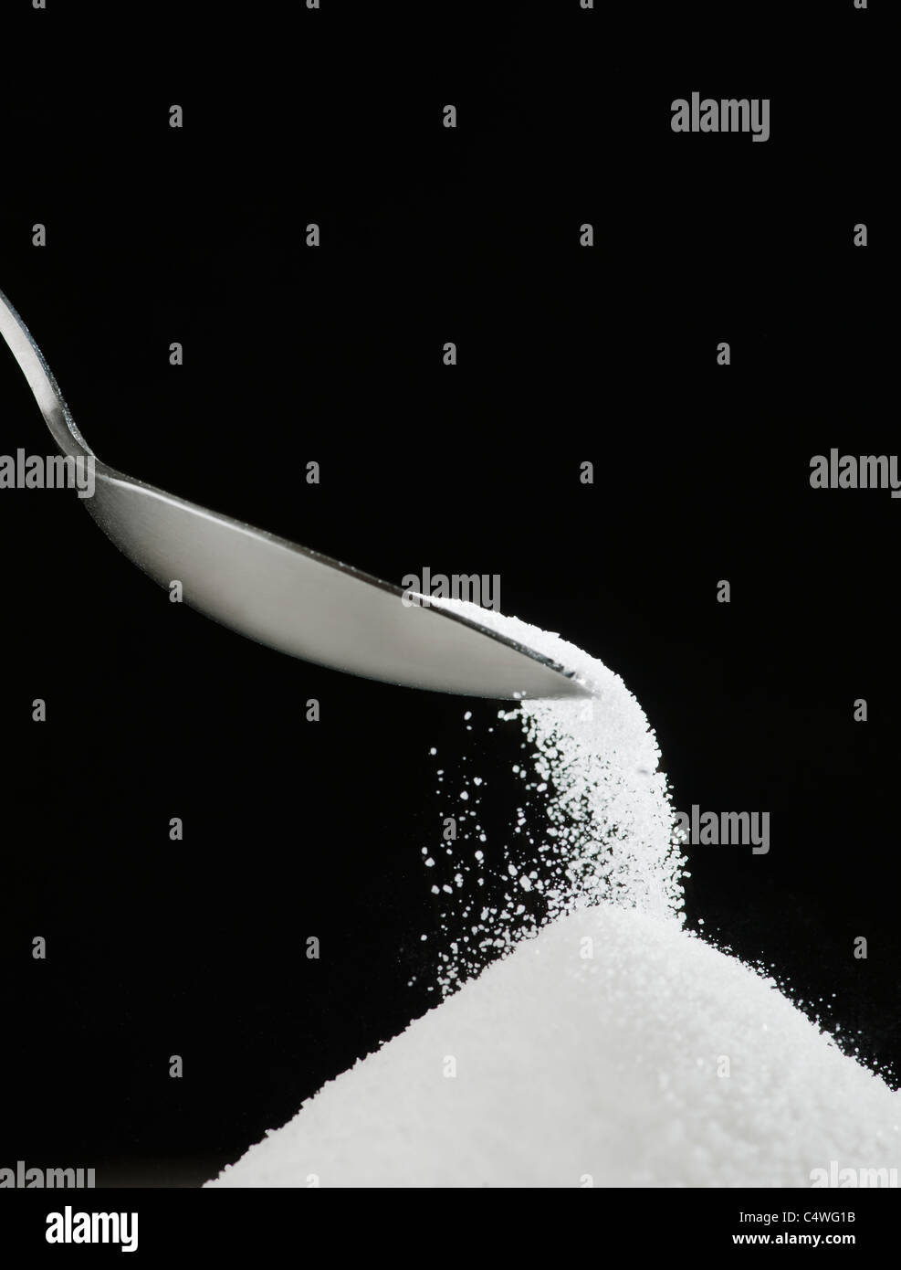Spoon and heap of sugar Stock Photo