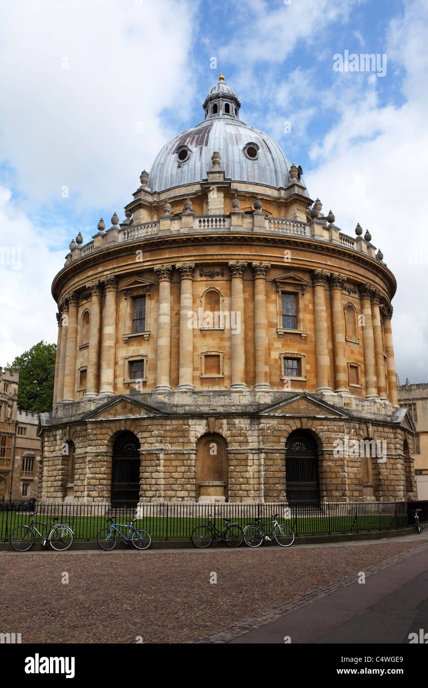 Bicycles are chained to the railings of the Radcliffe Camera on Radcliffe Square in Oxford, England. Stock Photo