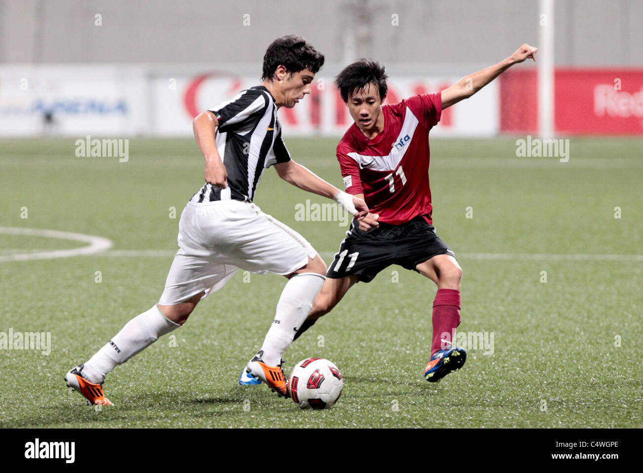 Jonathan Tan of Singapore U16(right) covers the run of Zarmanian Lorenzo during the 23rd Canon Lion City Cup. Stock Photo