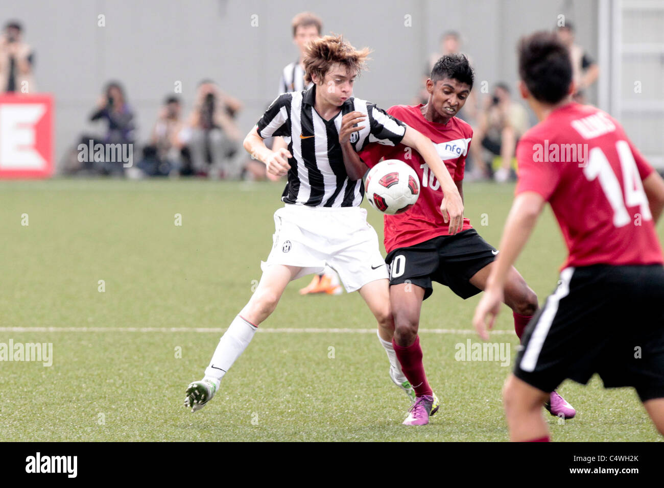 Giannarelli Andrea of Juventus FC U15(left) and Hanafi Akbar battle for the ball during the 23rd Canon Lion City Cup Stock Photo